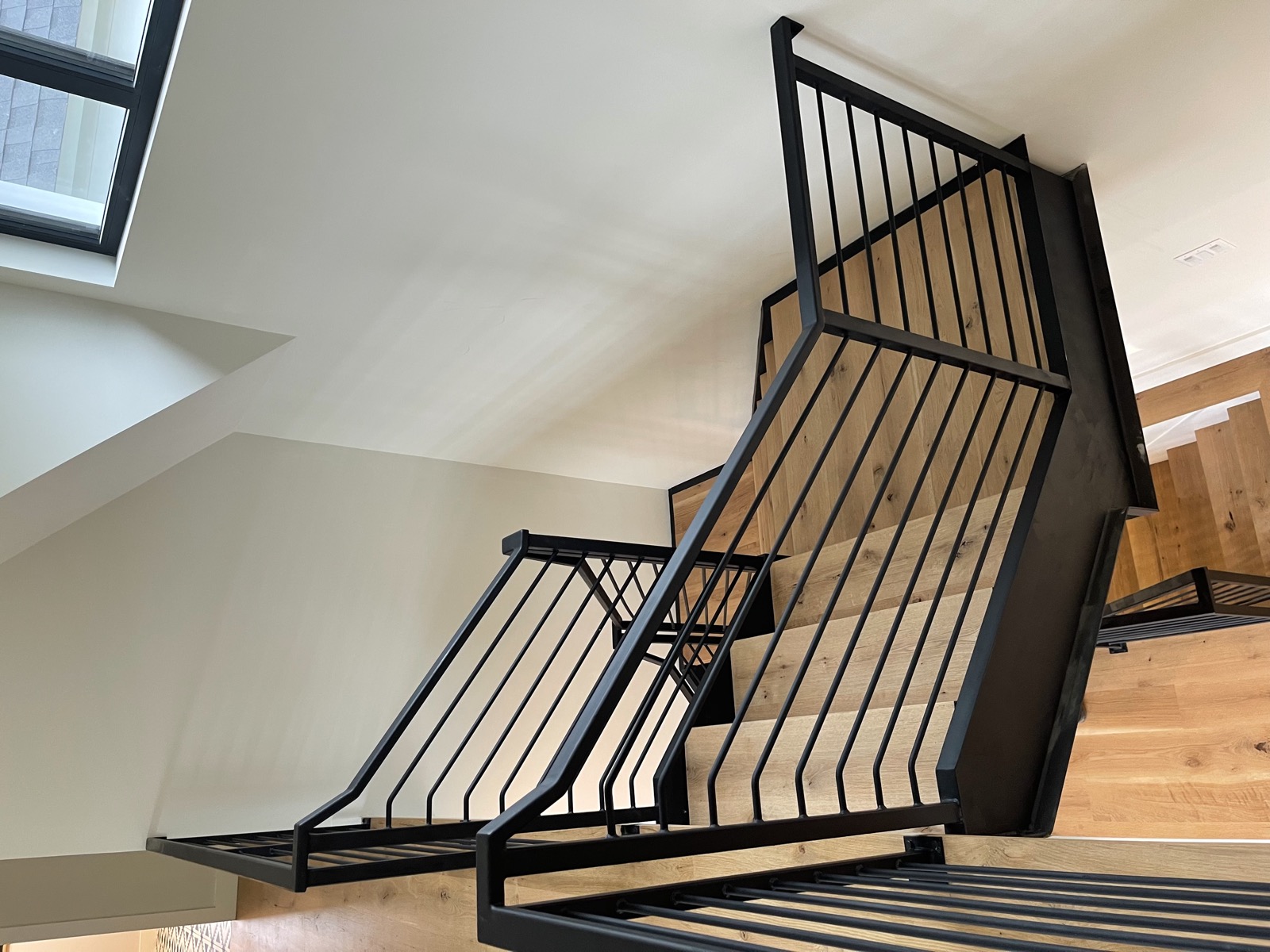 Vertical bar iron railing on multi-story staircase