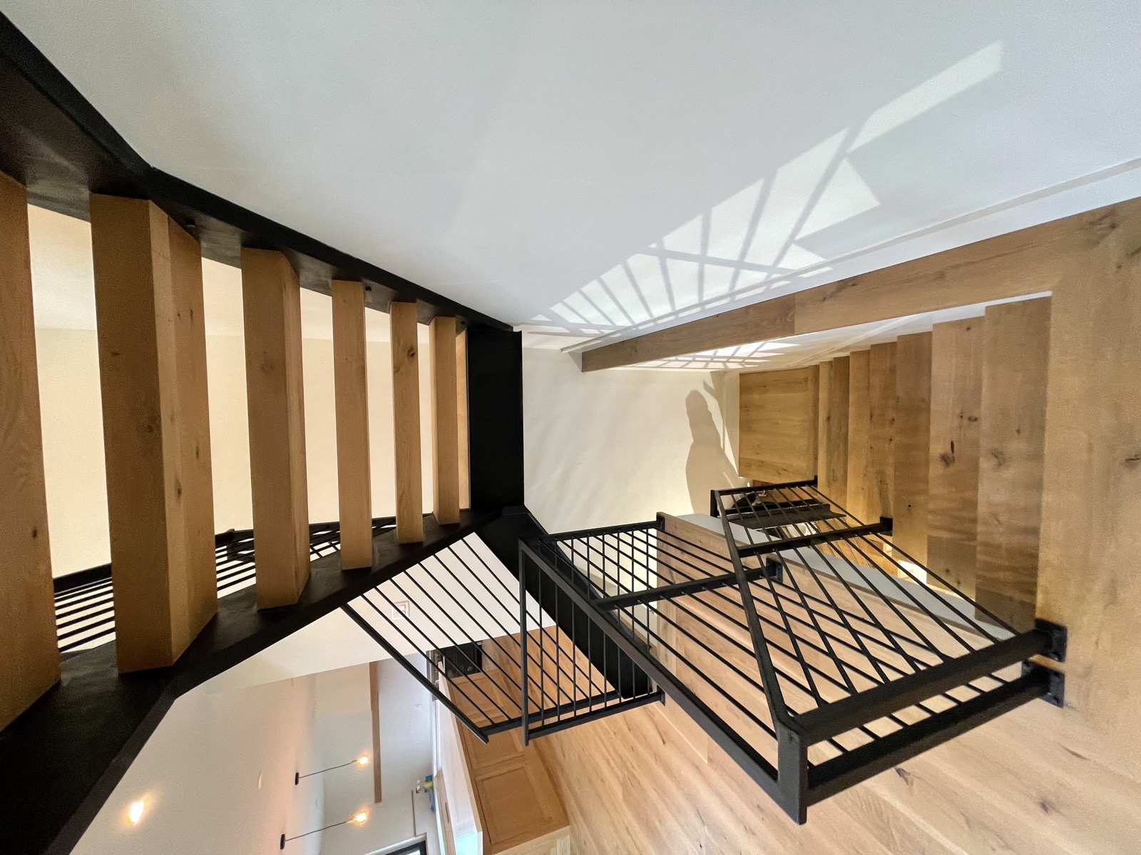 Iron railing with wood slats under skylight