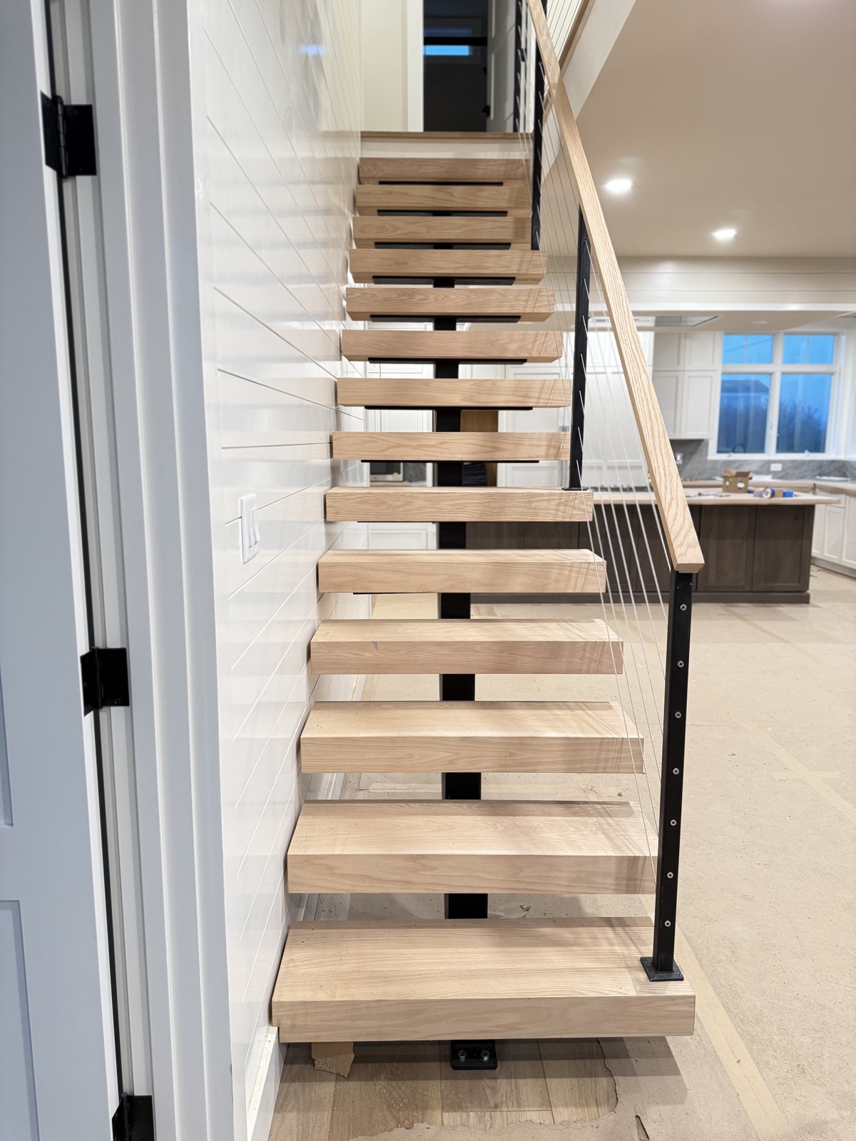 Floating cable staircase in open kitchen